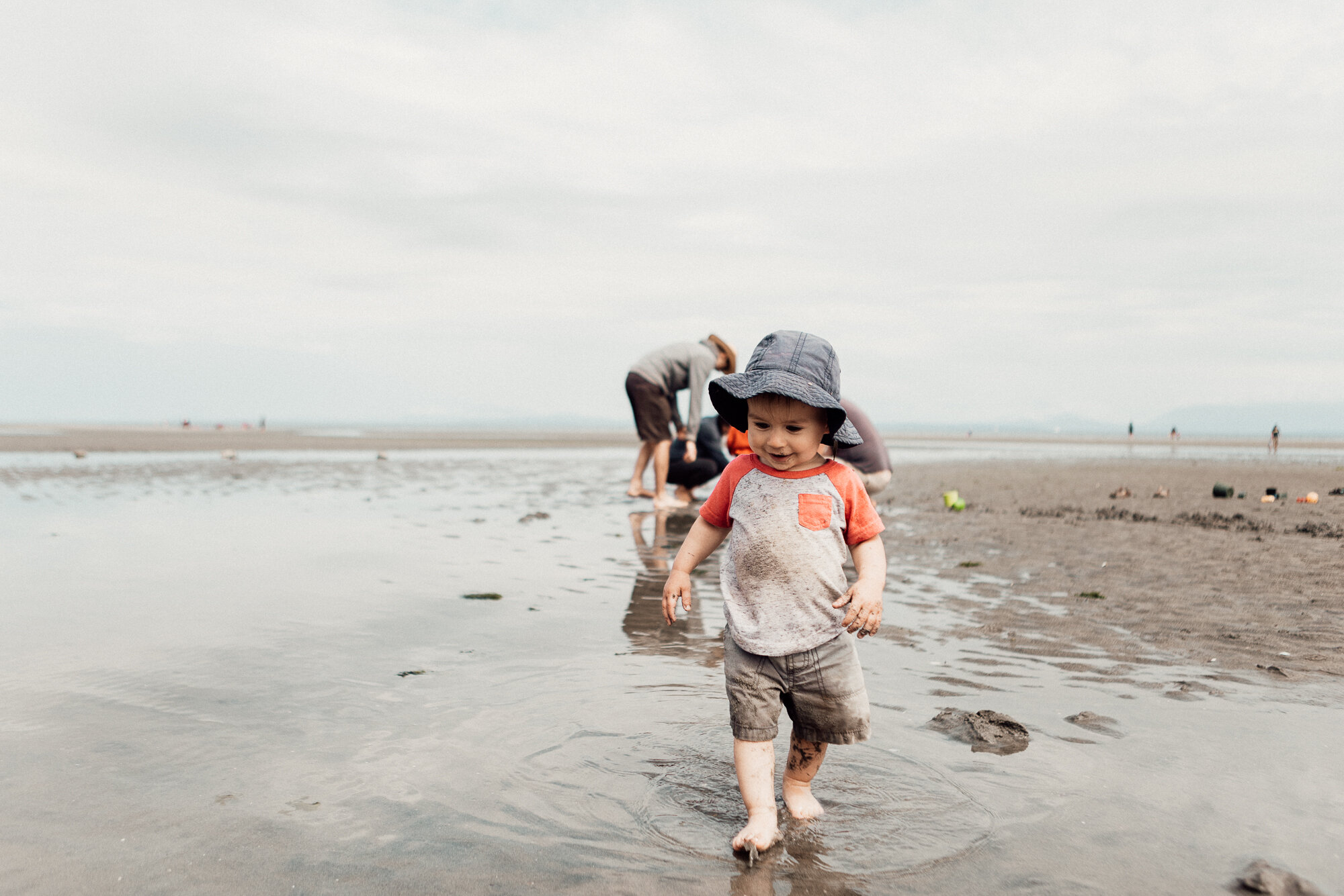 Cute toddler explores tide pools at Miracle Beach on Vancouver Island.jpg
