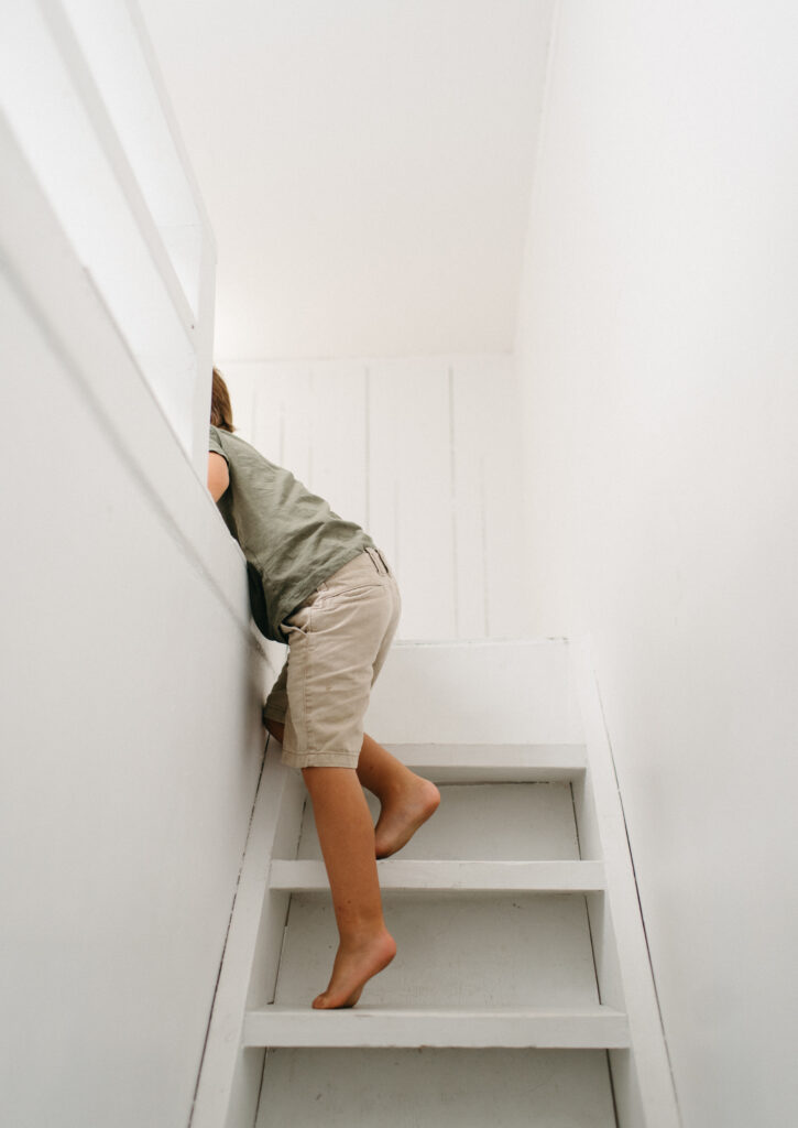 Legs of a little boy as he climbs stairs