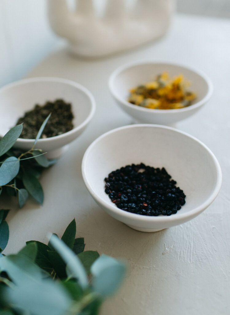 Bowls of seeds and herbs to produce herbal tea