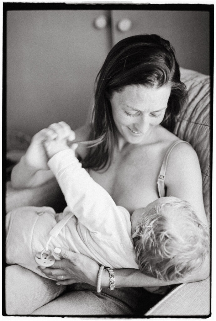 black and white film photo of mother breastfeeding her baby - geelong newborn photographer