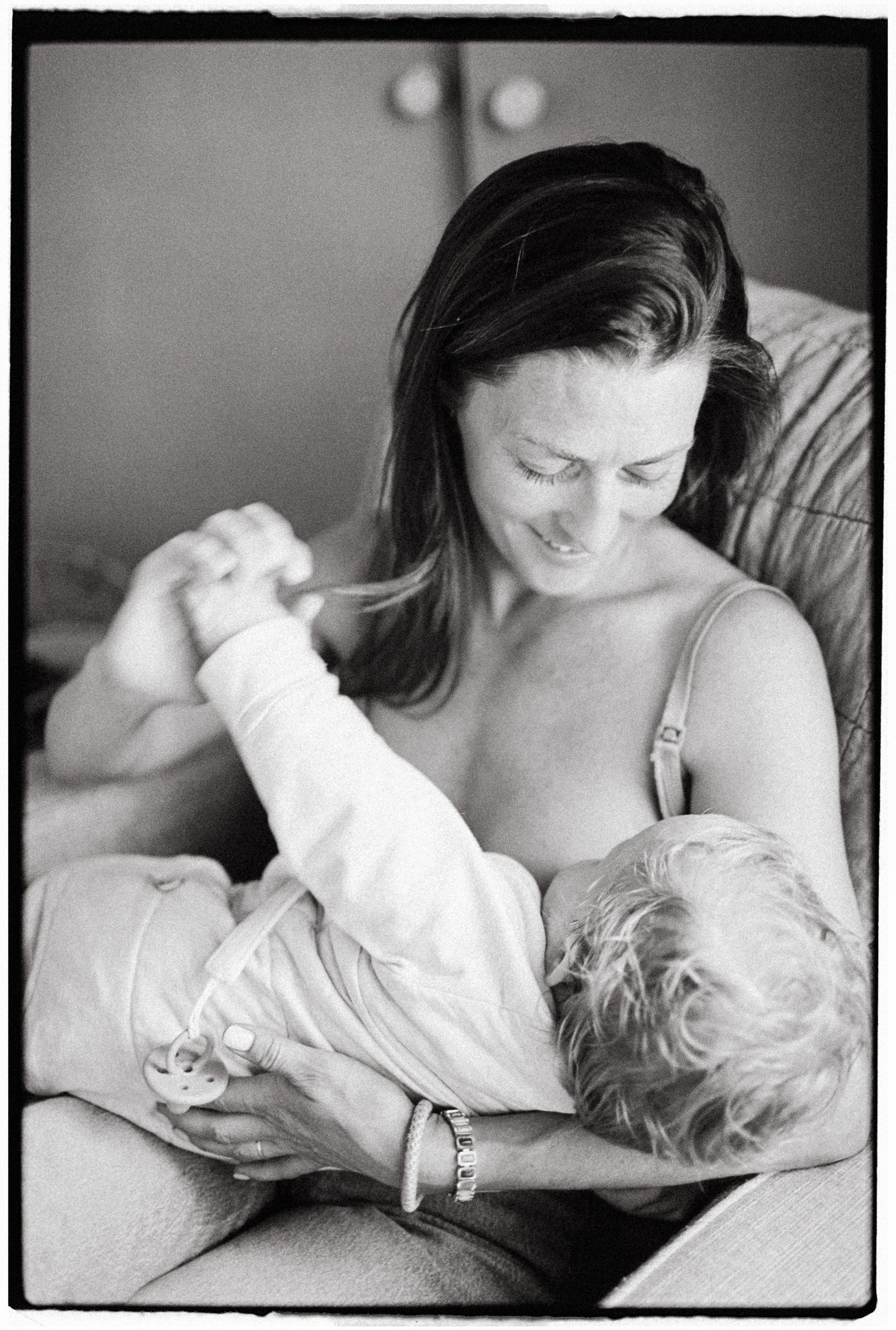 black and white film photo of mother breastfeeding her baby - geelong newborn photographer