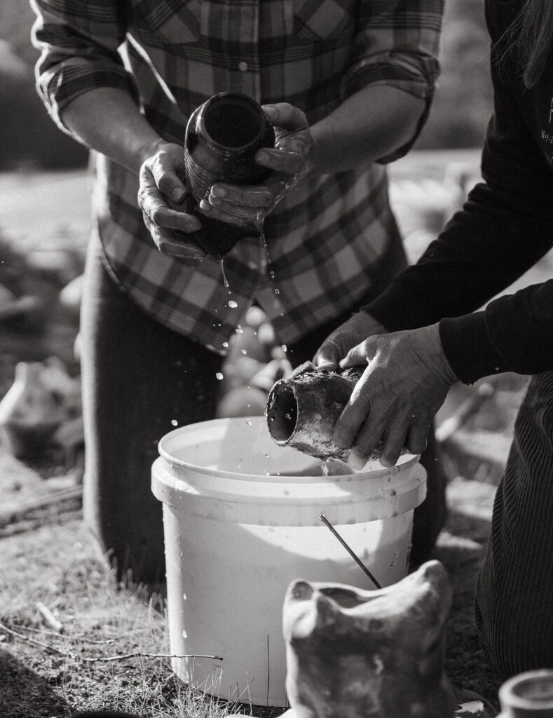 Lauren McQuade handmade Surf Coast ceramicist potter opens the pit kiln at the 2024 Surf Coast Arts Trail | Photo by Bobby Dazzler Photography