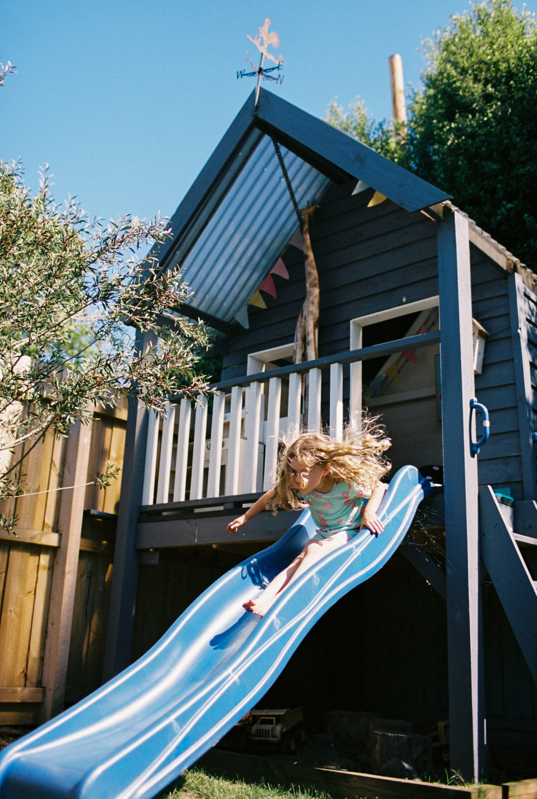 girl goes fast down the slide at geelong family photoshoot