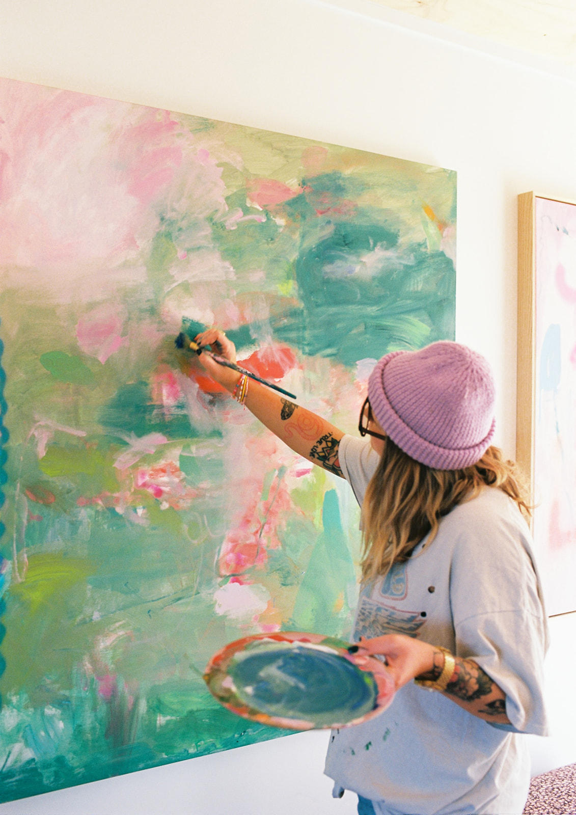 Kate Eliza Studio paints an abstract expressionist painting on 35mm film during an artist studio brand photoshoot with Bobby Dazzler Photography