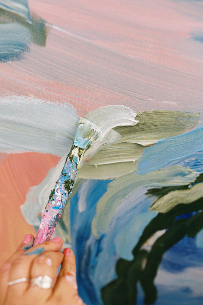 An extreme close up of a paintbrush held by Erin Reinboth, shot on analogue film